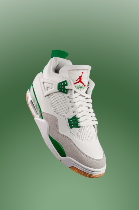 A green and white high-top sneaker on a green backdrop