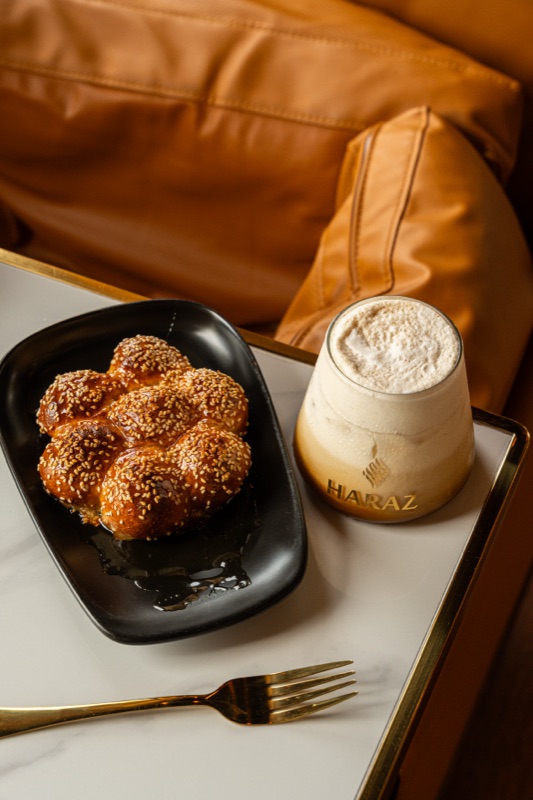 An iced latte and a sesame pastry
